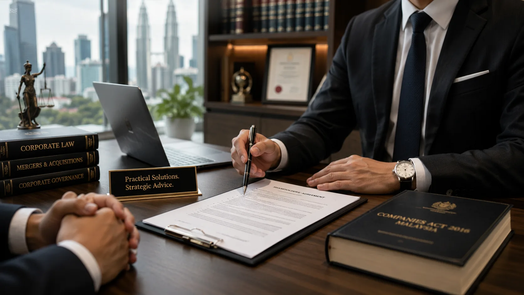 An advisor in a suit reviewing a document with a client across a desk, with a Companies Act 2016 volume and the Kuala Lumpur skyline through the window