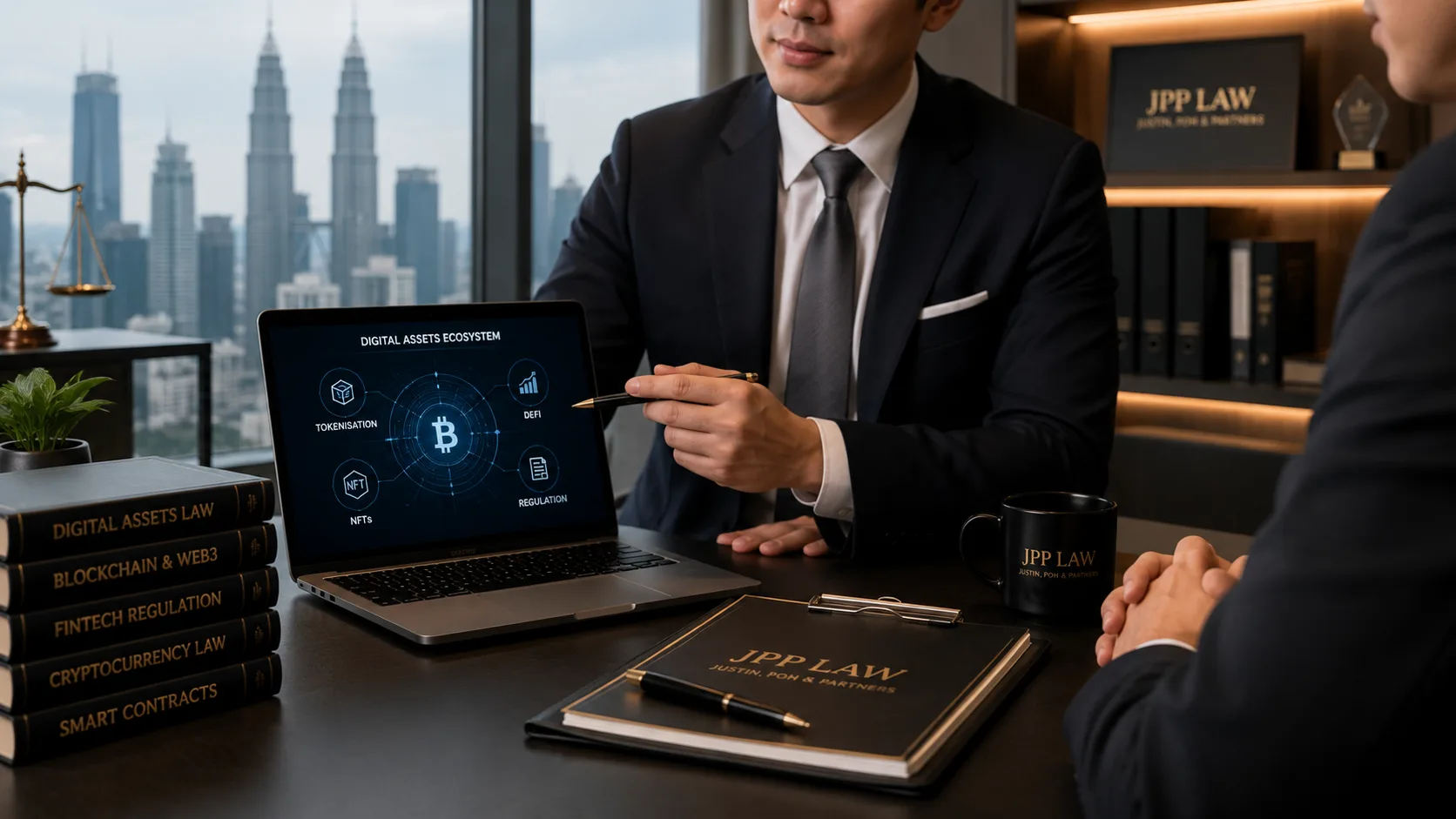 An advisor pointing a pen at a laptop showing a digital asset ecosystem diagram, with a JPP LAW folder on the desk and the Kuala Lumpur skyline through the window